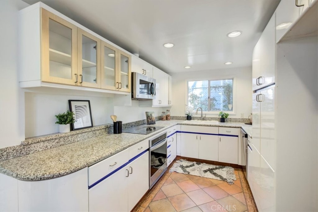 1980 El Arbolita Drive Glendale, CA 91208 - Photo 13 of 43 a kitchen with stainless steel appliances granite countertop a sink and cabinets