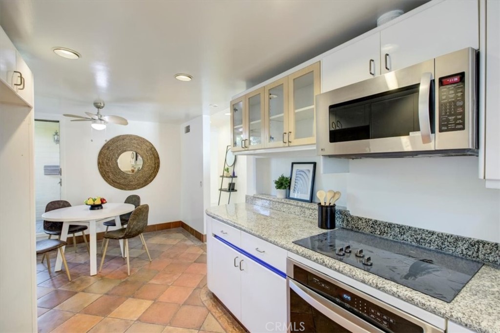 1980 El Arbolita Drive Glendale, CA 91208 - Photo 15 of 43 a kitchen with a stove a sink and a microwave