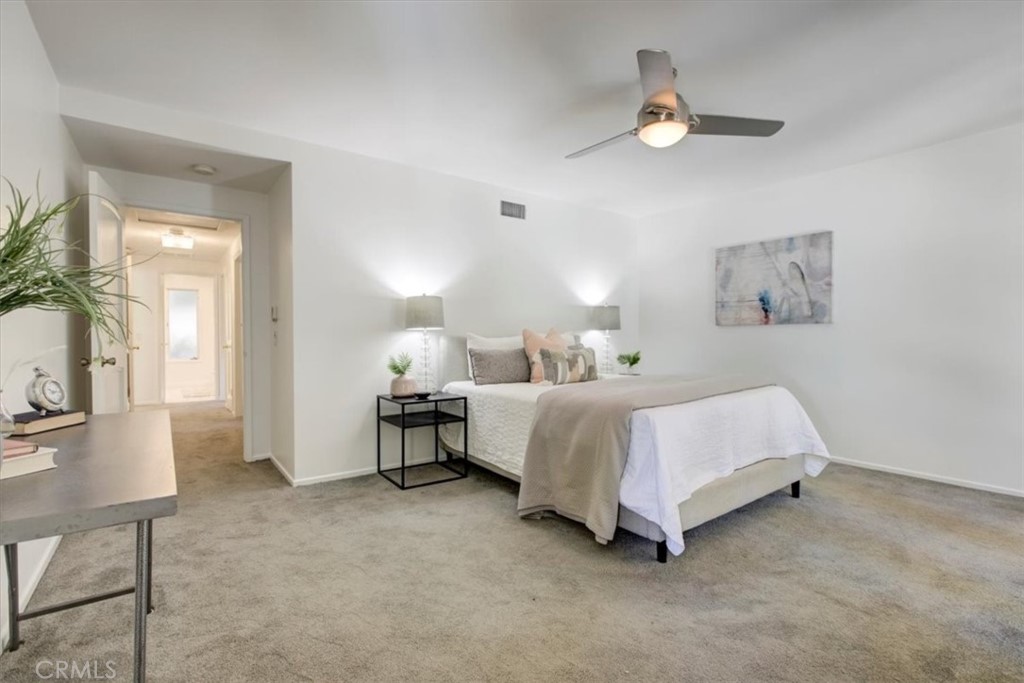 1980 El Arbolita Drive Glendale, CA 91208 - Photo 24 of 43 a spacious bedroom with a bed painting on wall and a large window