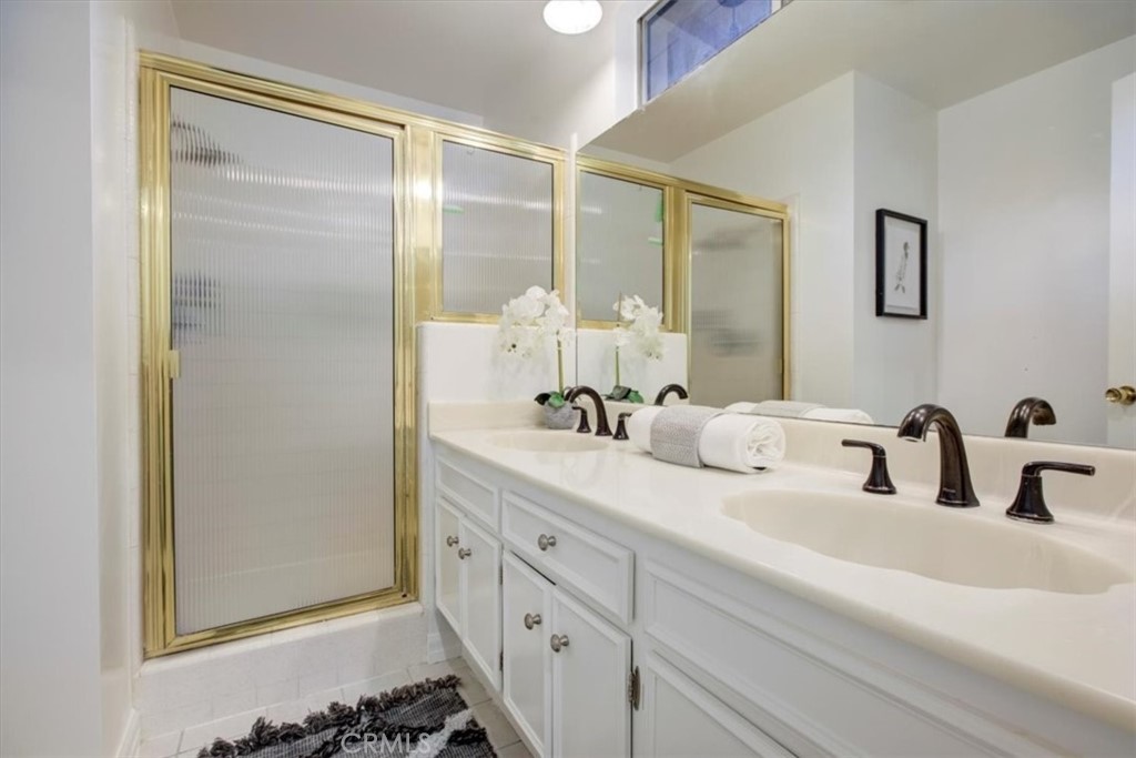 1980 El Arbolita Drive Glendale, CA 91208 - Photo 28 of 43 a bathroom with a double vanity sink mirror and shower