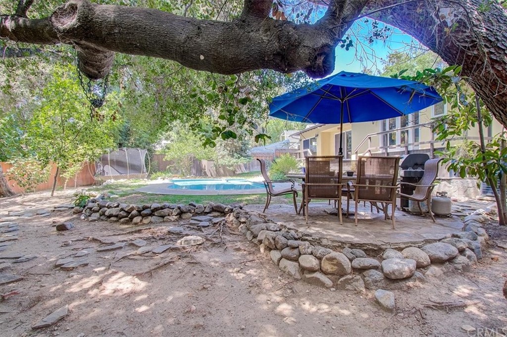 1980 El Arbolita Drive Glendale, CA 91208 - Photo 35 of 43 a view of a chairs and table under an umbrella