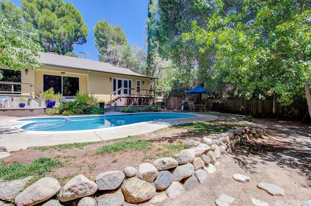 1980 El Arbolita Drive Glendale, CA 91208 - Photo 37 of 43 a front view of a house with a yard and potted plants
