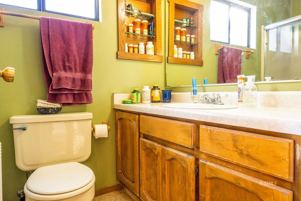 834 West Graaf Avenue Ridgecrest, CA 93555 - Photo 30 of 39 a bathroom with a toilet sink and mirror