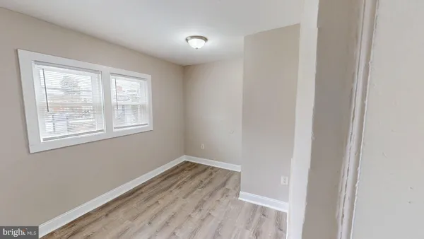 a view of a room with wooden floor and windows
