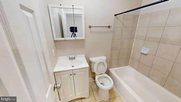 a white toilet sitting next to a bathroom sink