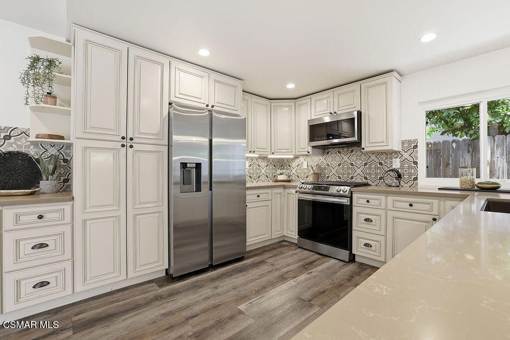 1772 Fred Avenue Simi Valley, CA 93065 - Photo 12 of 43 a kitchen with a refrigerator stove and white cabinets