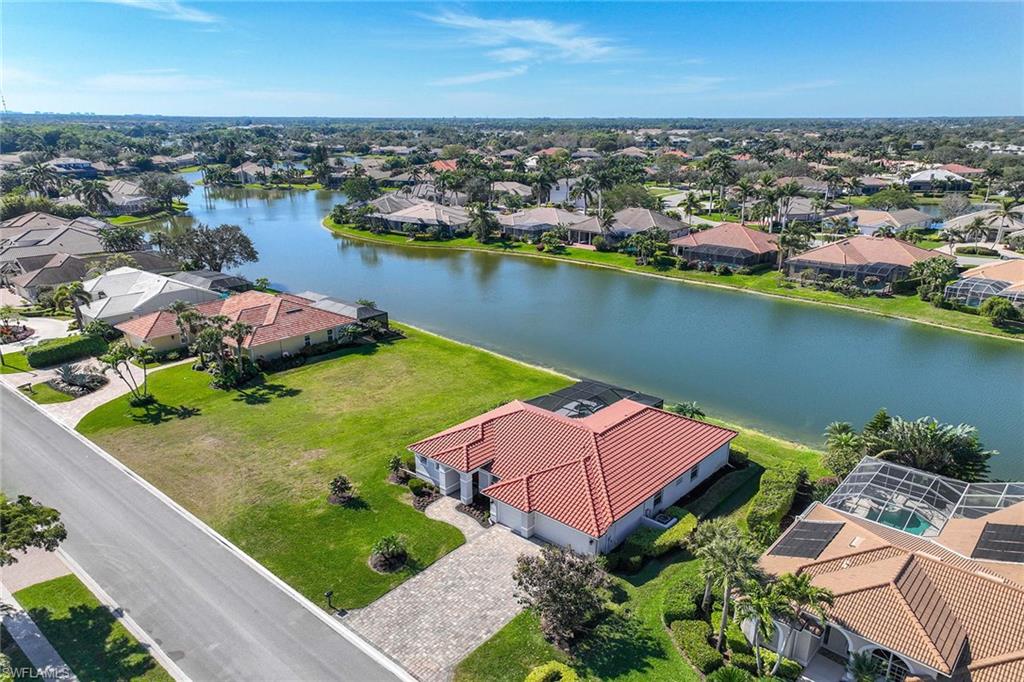 8945 Lely Island Circle Naples, FL 34113 - Photo 1 of 4 an aerial view of a houses with a lake view