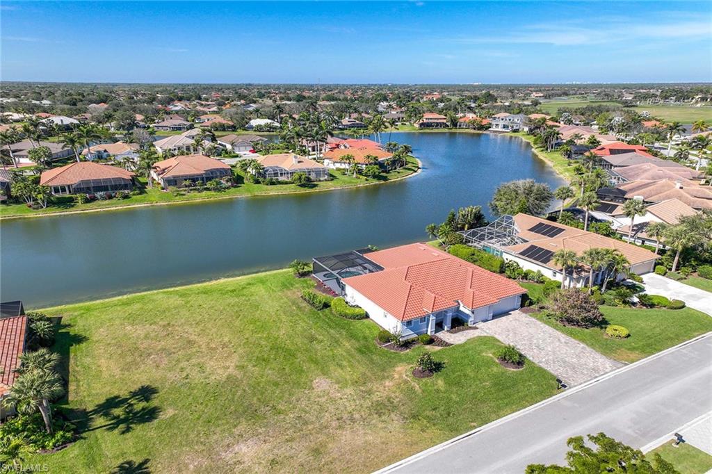 8945 Lely Island Circle Naples, FL 34113 - Photo 2 of 4 an aerial view of a house with a lake view