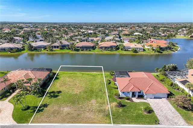 an aerial view of a house with a lake view