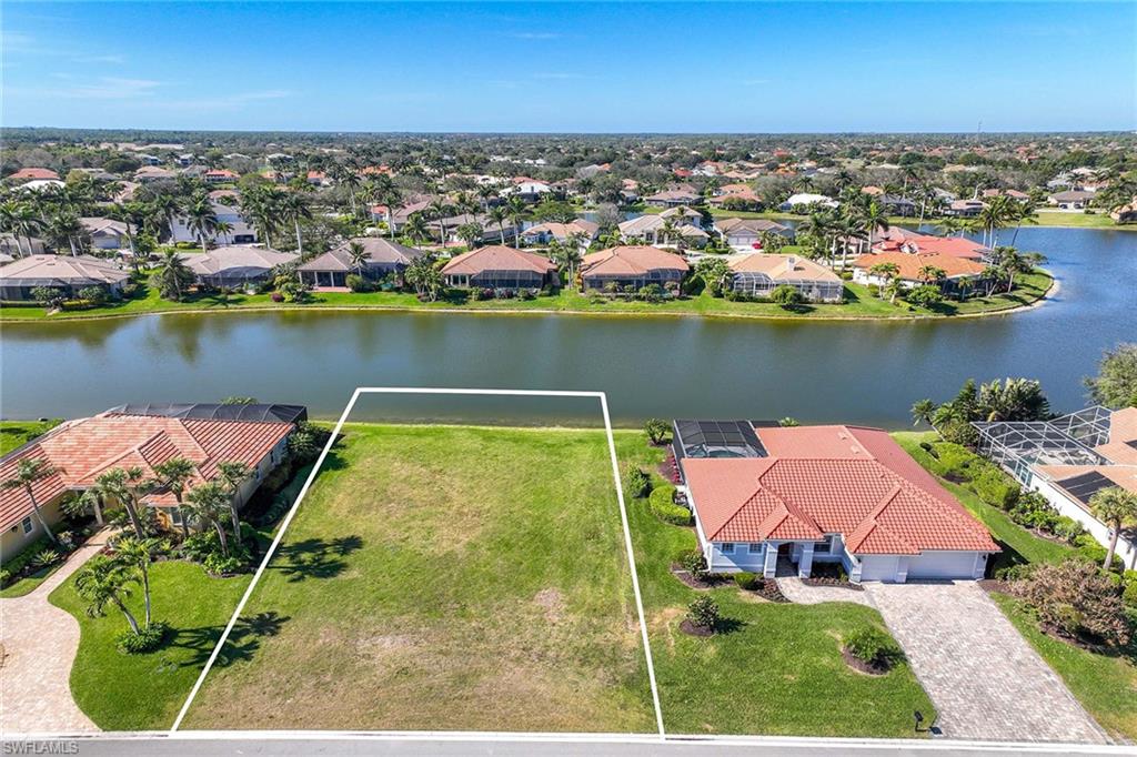 8945 Lely Island Circle Naples, FL 34113 - Photo 3 of 4 an aerial view of a house with a lake view