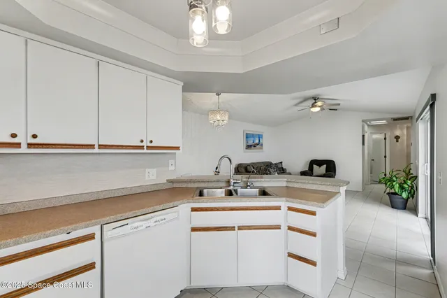 a kitchen with a sink cabinets and window