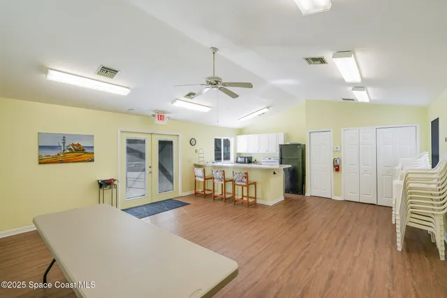 a living room with kitchen island furniture and a wooden floor