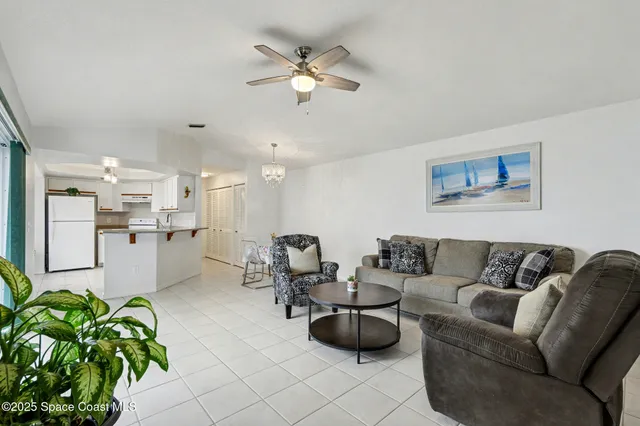 a living room with furniture and kitchen view
