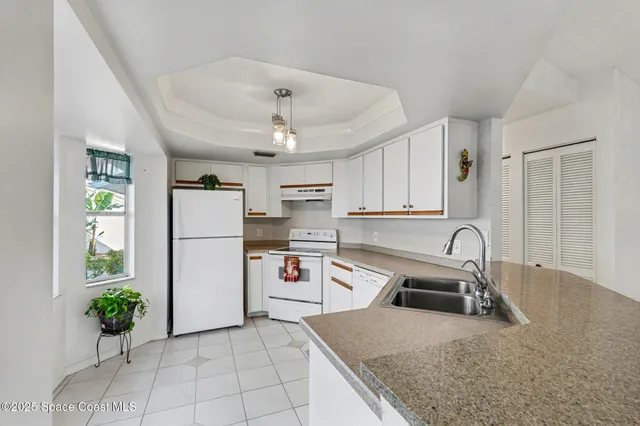 a kitchen with refrigerator and stove