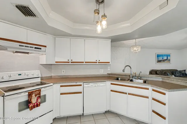 a kitchen with appliances a sink and cabinets