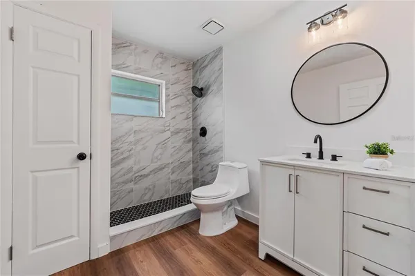 a bathroom with a toilet a sink and a mirror