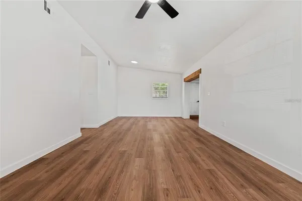 an empty room with closet and windows