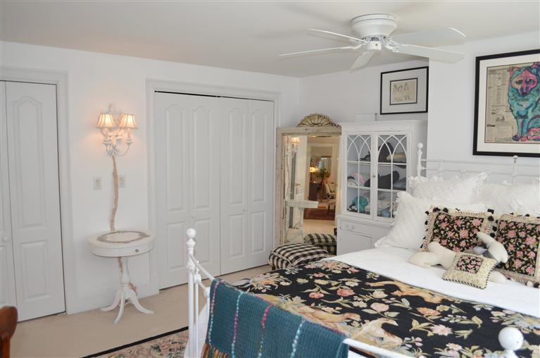 1480 South County Road Osterville, MA 02655 - Photo 10 of 12 a bedroom with a bed and a chandelier