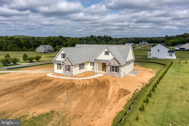 a view of a sign board with flower in front of it