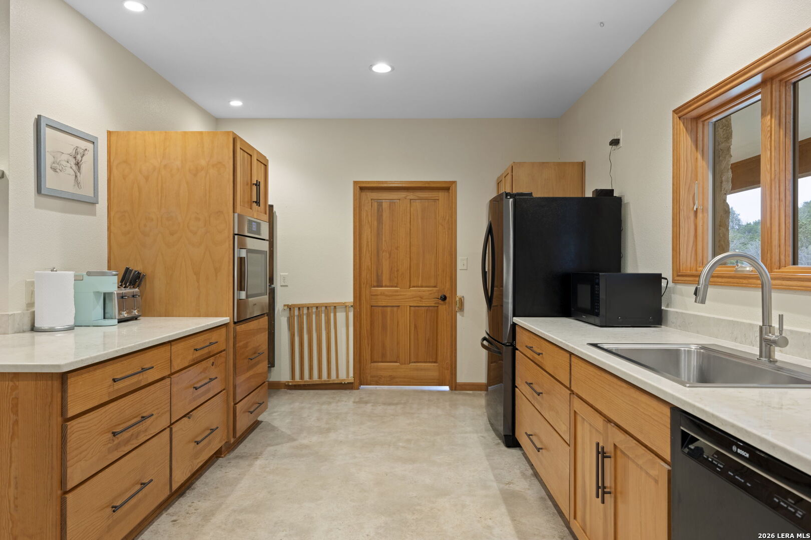 2269 Old Rocksprings Road Leakey, TX 78873 - Photo 13 of 50 a kitchen with stainless steel appliances granite countertop a refrigerator and a sink