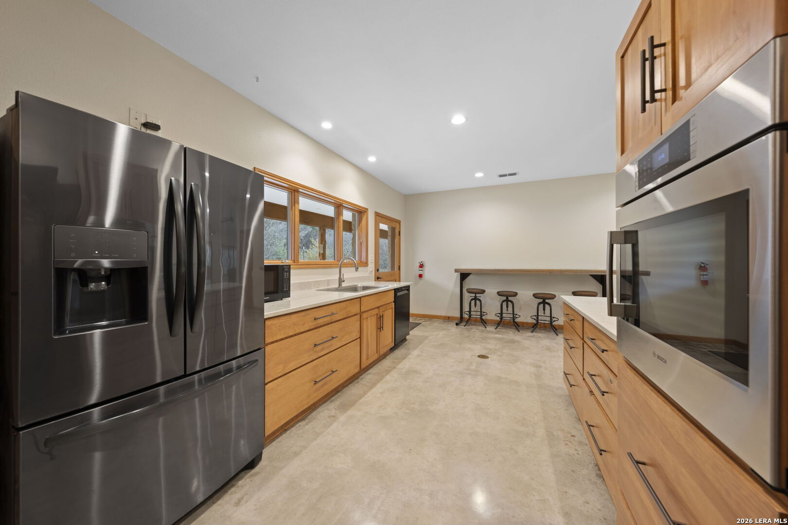 2269 Old Rocksprings Road Leakey, TX 78873 - Photo 14 of 50 a large kitchen with stainless steel appliances a refrigerator and a stove top oven