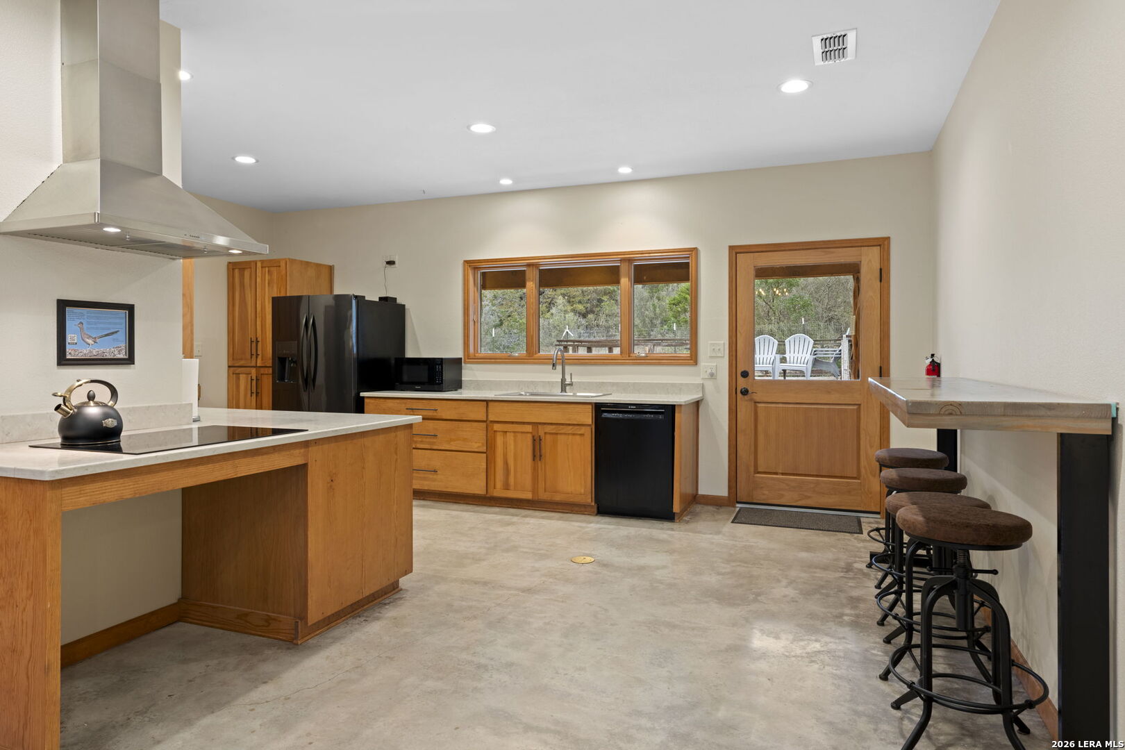 2269 Old Rocksprings Road Leakey, TX 78873 - Photo 8 of 50 a large kitchen with kitchen island a large counter top space a sink stainless steel appliances and cabinets