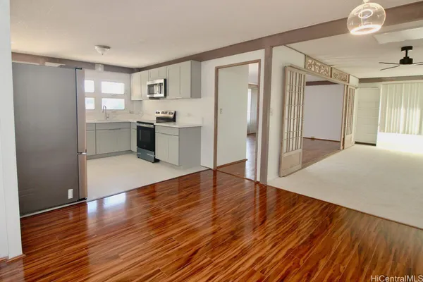 a view of a kitchen with wooden floor and a kitchen
