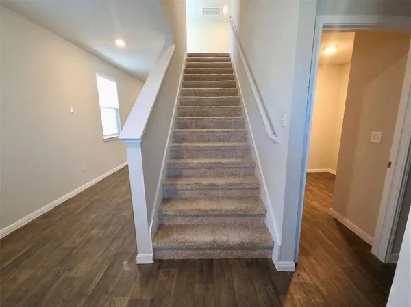 a view of entryway and hall with wooden floor