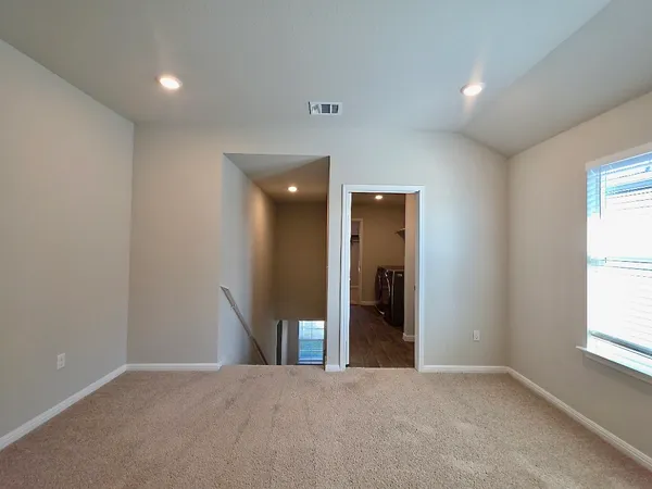 an empty room with windows and entrance