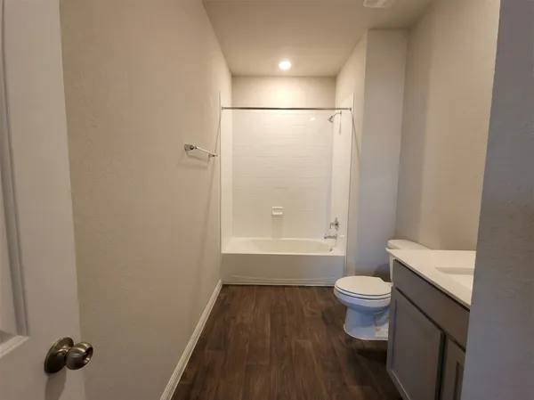 a bathroom with a toilet sink a mirror and shower