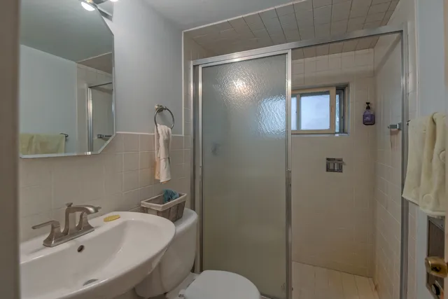 a bathroom with a sink toilet and shower