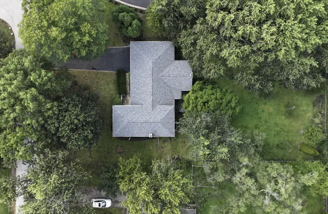 an aerial view of a house with a yard
