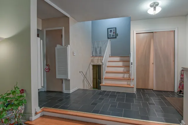 a view of entryway and hall with wooden floor