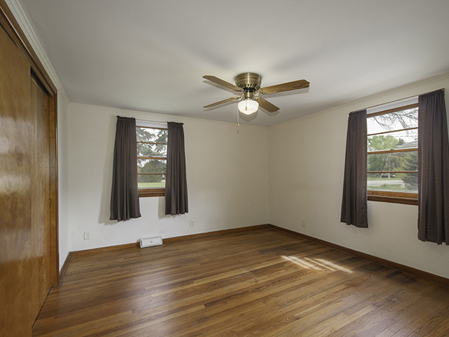 1685 Sheffer Road Aurora, IL 60505 - Photo 11 of 15 a view of an empty room with wooden floor and a window
