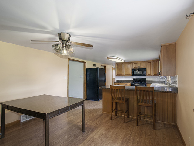 1685 Sheffer Road Aurora, IL 60505 - Photo 3 of 15 a view of a dining room with furniture and wooden floor