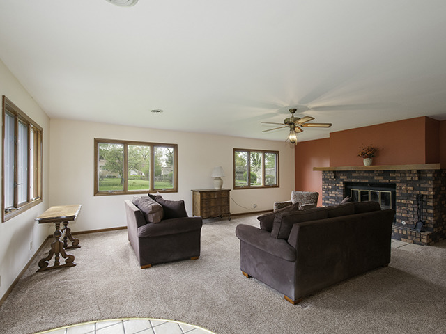 1685 Sheffer Road Aurora, IL 60505 - Photo 5 of 15 a living room with furniture a fireplace and a large window