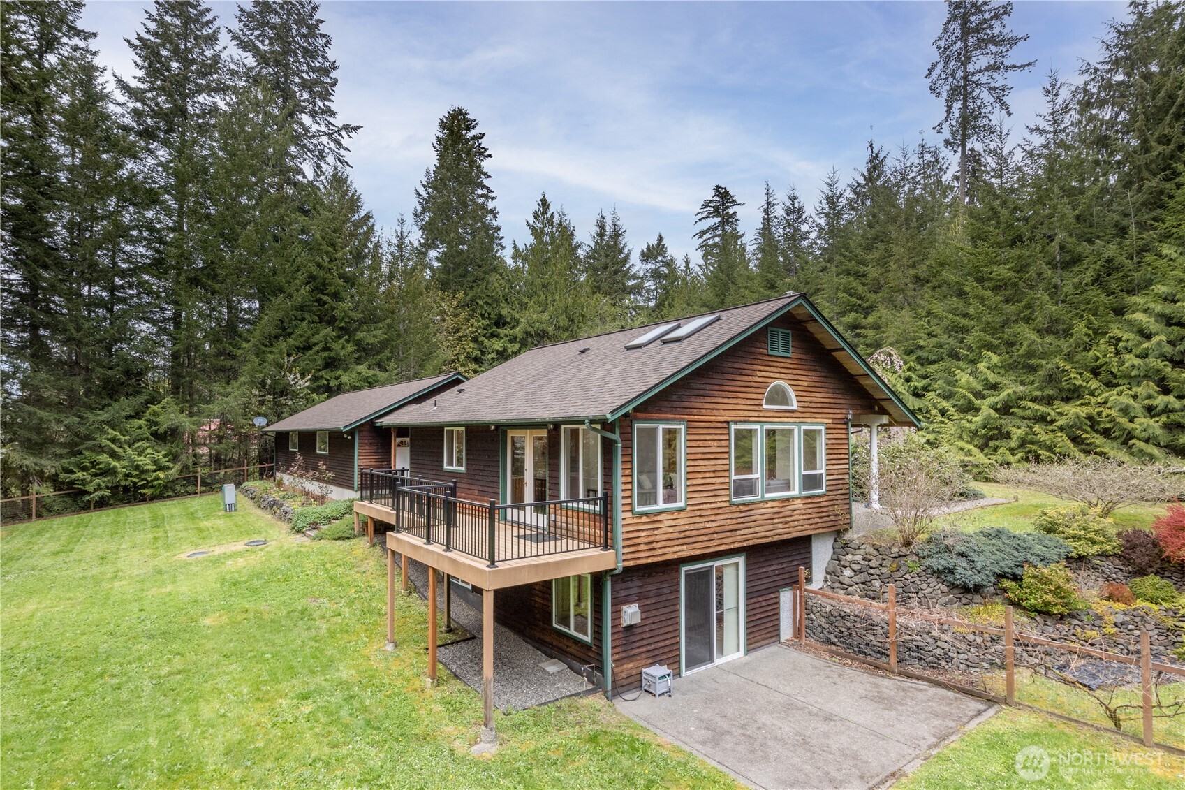 2882 Beaver Valley Road Port Ludlow, WA 98365 - Photo 2 of 34 a white house that has a small yard and large trees