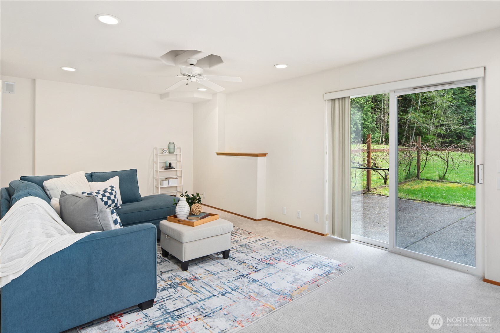 2882 Beaver Valley Road Port Ludlow, WA 98365 - Photo 21 of 34 a living room with furniture and a floor to ceiling window