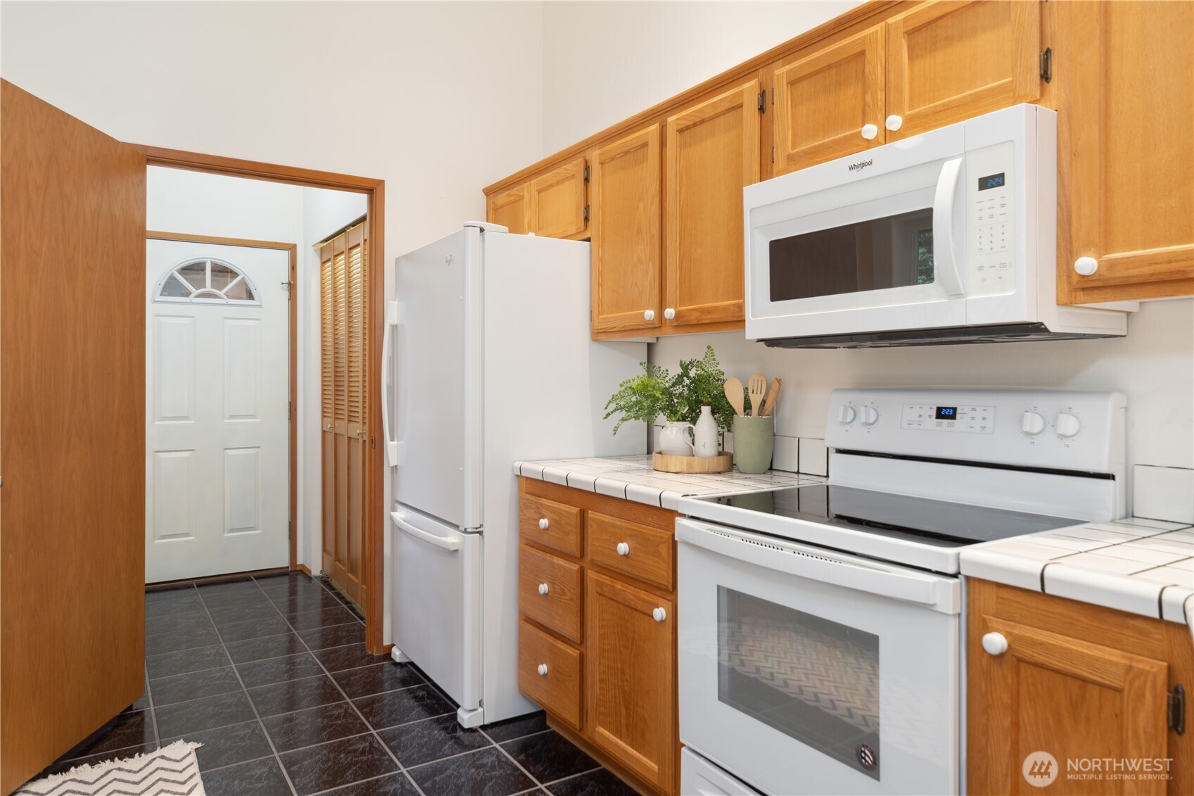 2882 Beaver Valley Road Port Ludlow, WA 98365 - Photo 10 of 34 a kitchen with stainless steel appliances white cabinets and a stove top oven