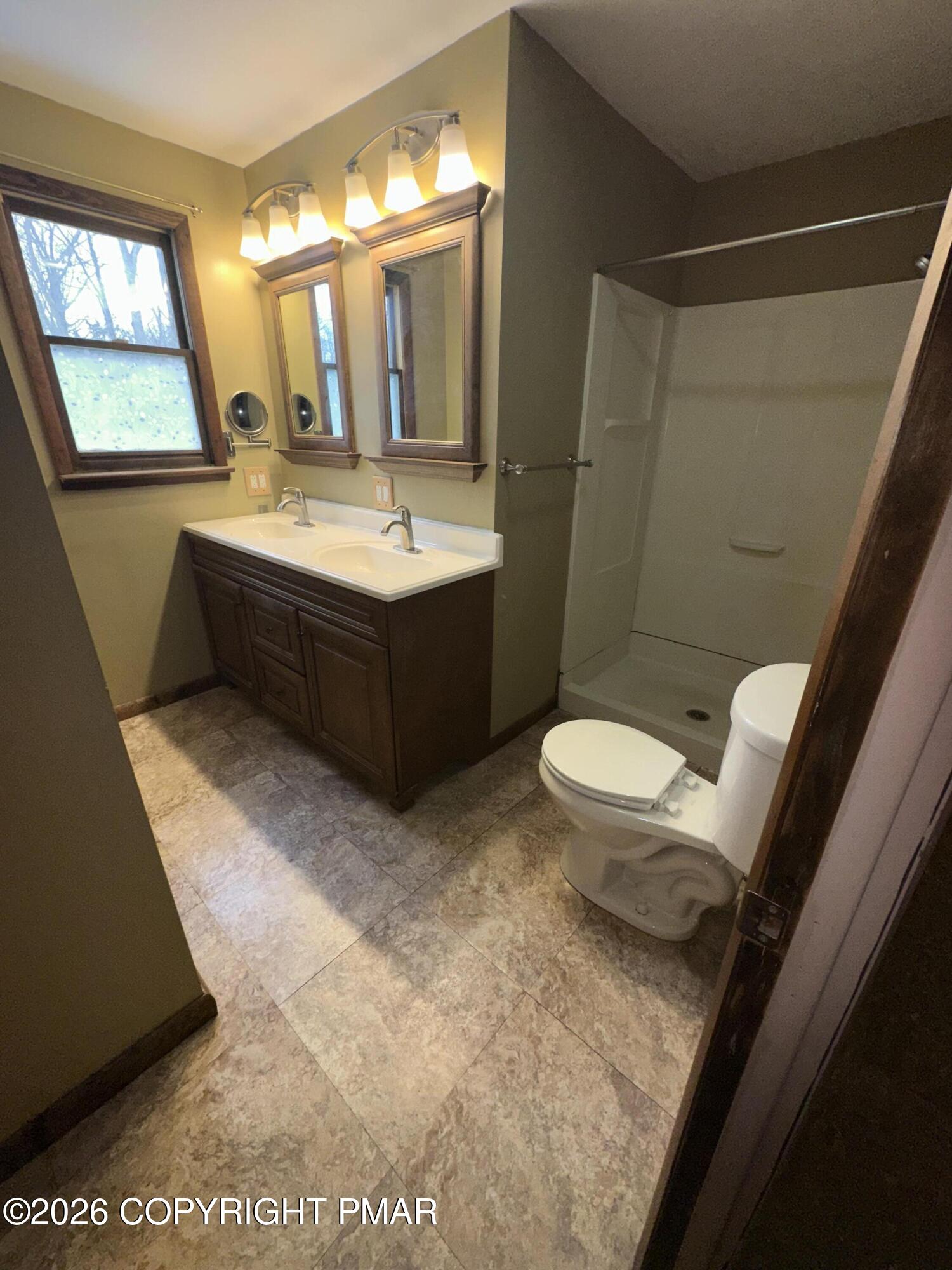 351 Charles Folly Road Bartonsville, PA 18321 - Photo 14 of 25 a bathroom with a bathtub sink mirror vanity and toilet