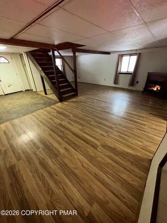 a view of a room with wooden floor