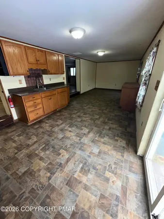 a large kitchen with stainless steel appliances granite countertop a refrigerator and a stove top oven