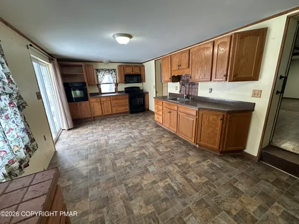 a view of a room with wooden floor