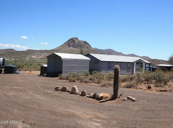 a view of a house with a sink yard fire pit and a road