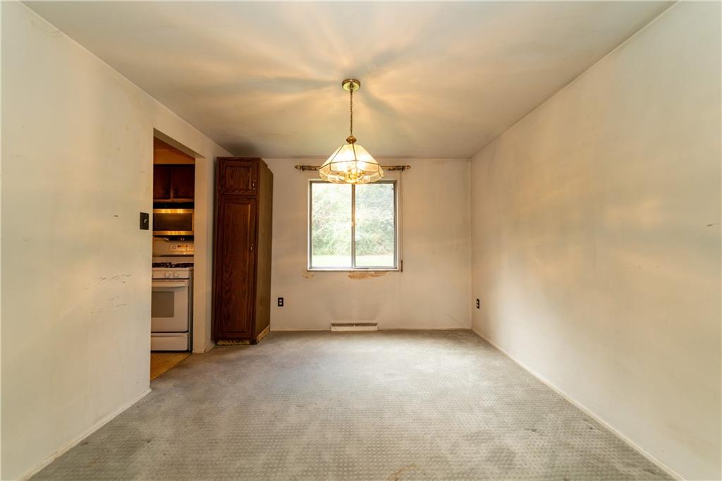 1050 Princeton Road Pittsburgh, PA 15205 - Photo 6 of 34 an empty room with windows and cabinet