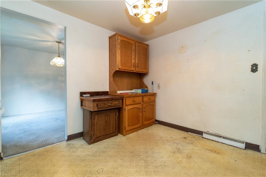 1050 Princeton Road Pittsburgh, PA 15205 - Photo 7 of 34 a kitchen with stainless steel appliances granite countertop a stove a sink and a refrigerator with wooden floor