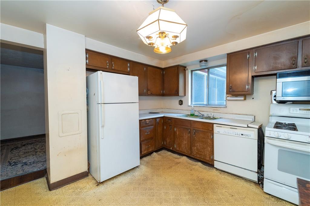 1050 Princeton Road Pittsburgh, PA 15205 - Photo 8 of 34 a kitchen with cabinets a refrigerator and a stove top oven