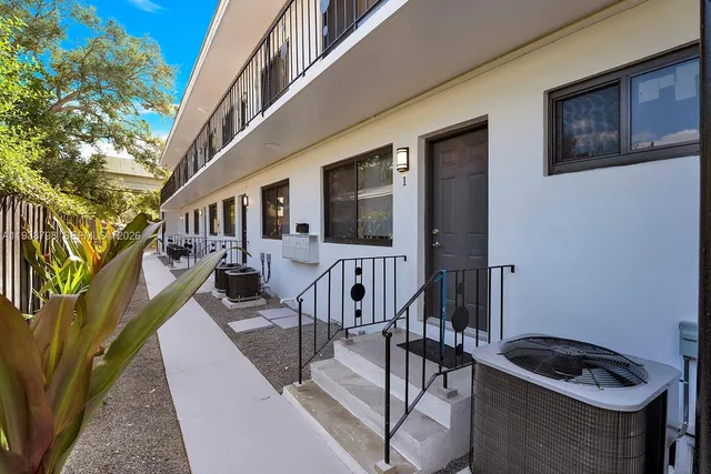 a front view of a house with outdoor seating