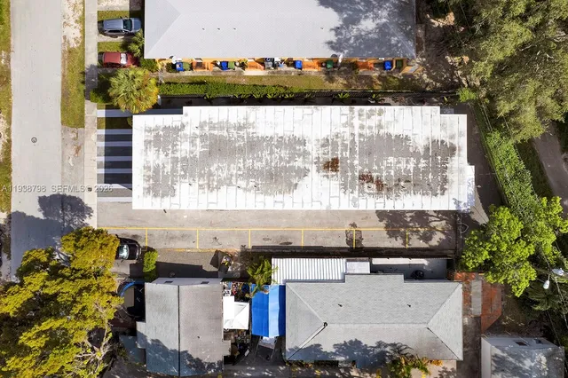 an aerial view of multiple houses with yard