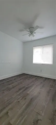 a view of an empty room and a window